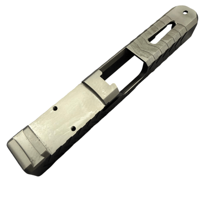 Close-up of a large knife blade with a textured tan-and-black handle and skeletonized grip, viewed diagonally. - Glock 19 Gen 5 RMR Cut Slide, Zigzag Serrations | Top Window , Mid State Firearms