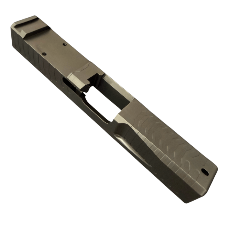 Close-up of a metallic pistol slide with milling marks and an ejection port (gun component). - Glock 19 Gen 3 RMR Slide | Black DLC - Matrix Drip Serrated , Mid State Firearms