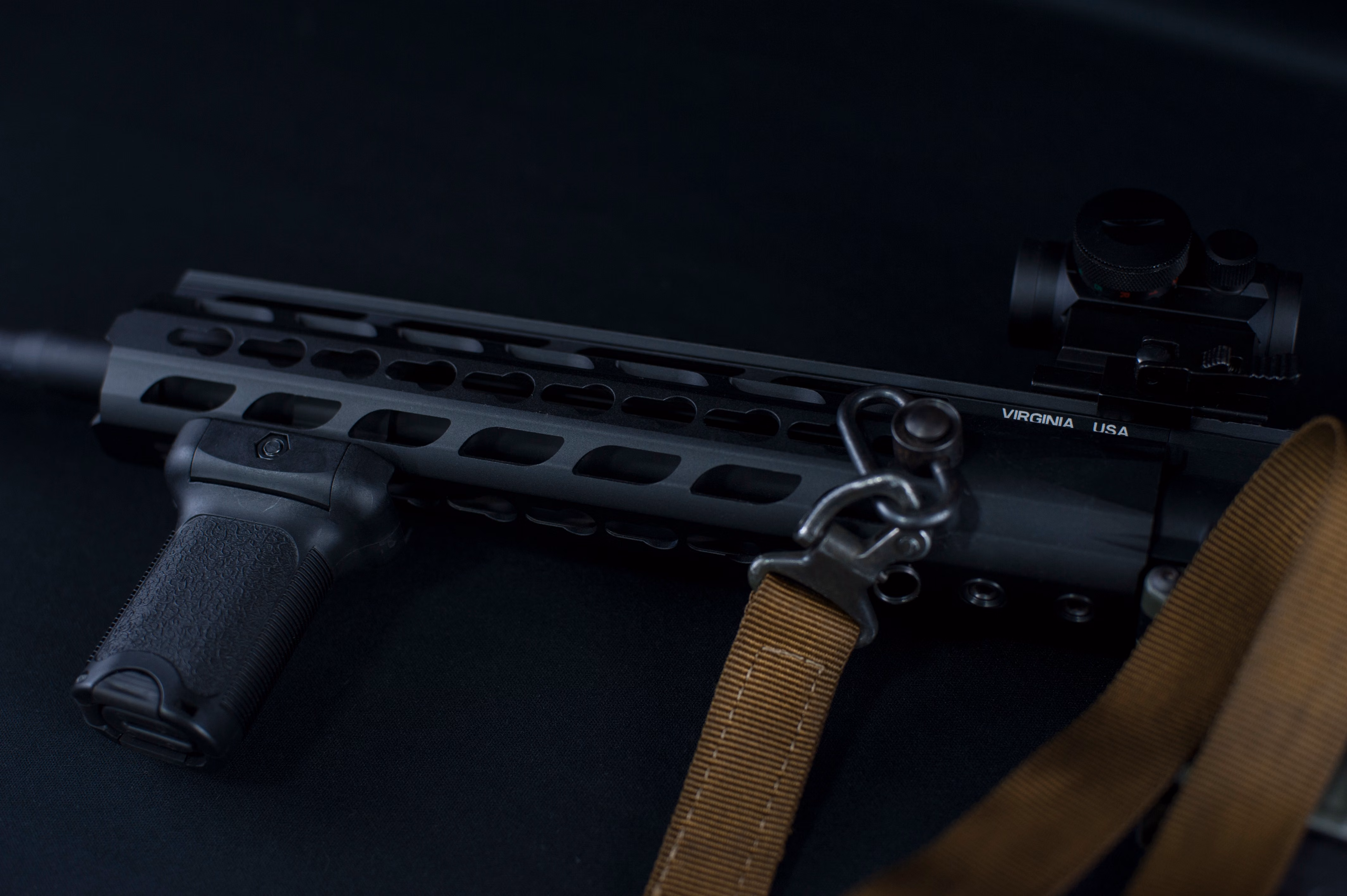 Close-up of an AR9 pistol upper receiver with M-LOK handguard, angled foregrip, red dot sight, and tan two-point sling, engraved 'Virginia USA' on the receiver. - Best Barrel Length for 9mm: A Practical AR9 Guide , Mid State Firearms