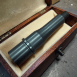 A compact optical eyepiece or telescope accessory resting inside a lined wooden case with a cream interior. - 4.5" 9mm AR15 Barrel | 4150 CMV Nitride AR9 Barrel 1/2x28 , Mid State Firearms